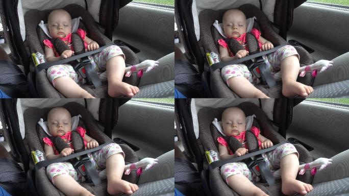睡在儿童汽车座椅上的女婴