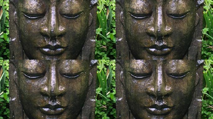 巴厘岛乌布热带花园里落水的佛陀。