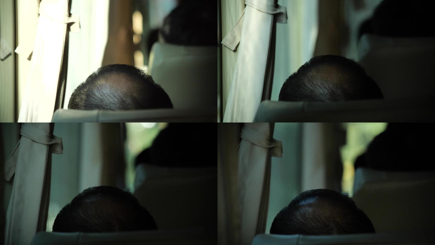 前排座位中年男人的秃顶