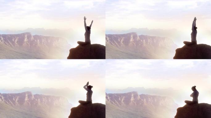 一个女人在山顶练习瑜伽