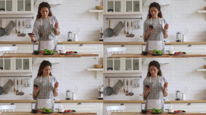 快乐妇女用手机查看菜谱准备蔬菜沙拉