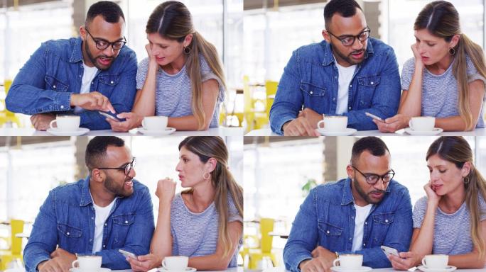 一对年轻夫妇白天坐在咖啡馆里使用手机