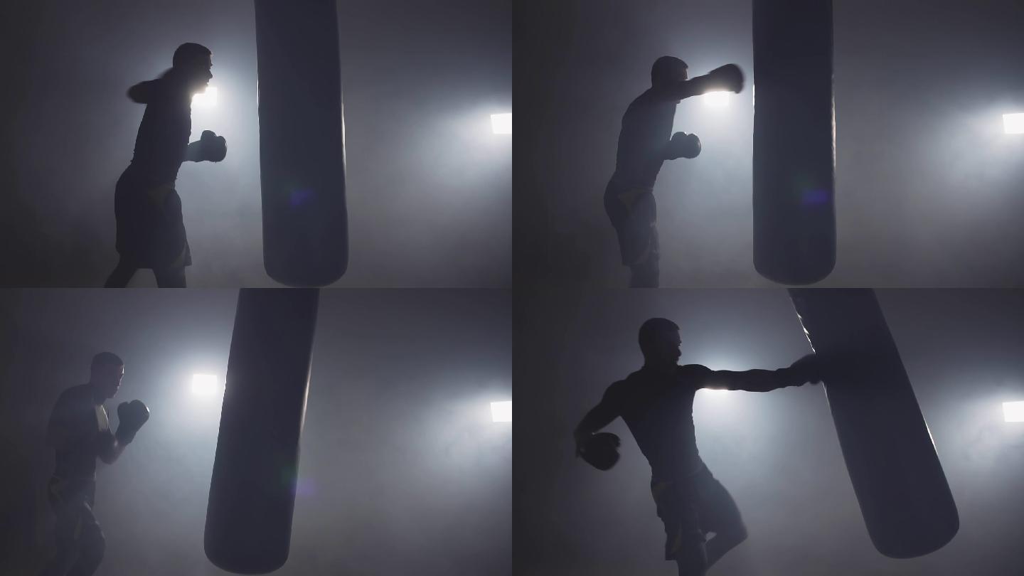 拳击手在黑暗的健身房打拳击袋慢动作