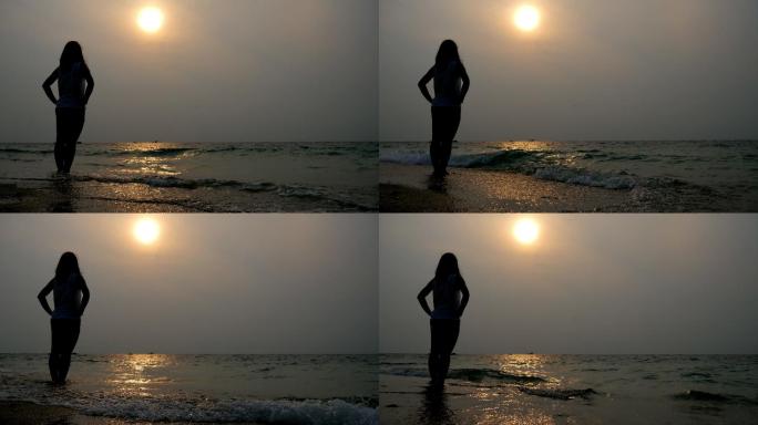 落日时分海滩上的孤独女人