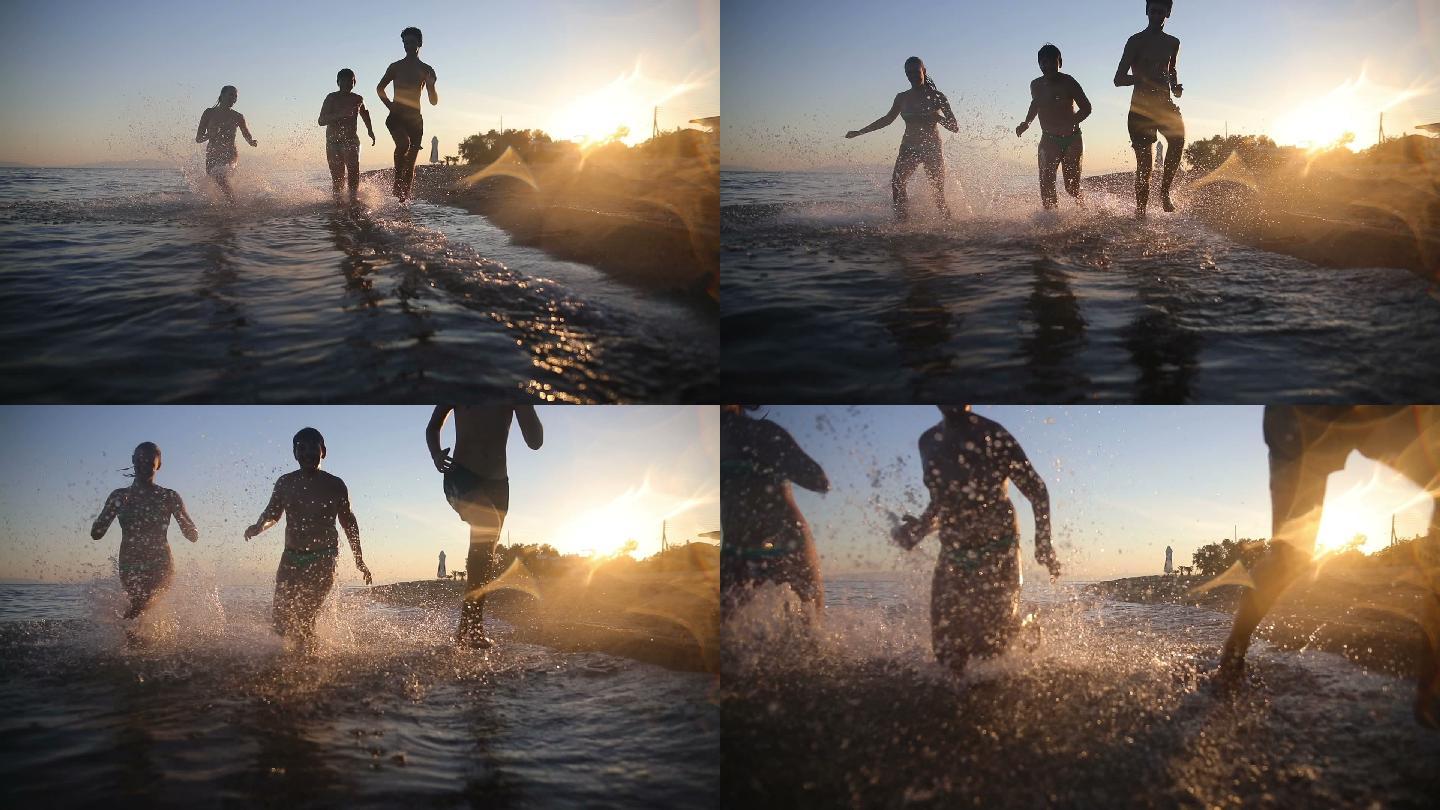 日落时分，兄弟姐妹在沙滩上奔跑