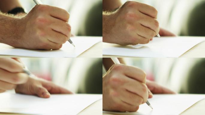 一个人用笔在空白页上写字