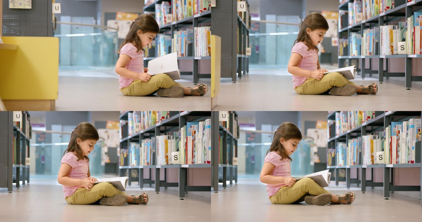 小女孩坐在图书馆的地板上看书