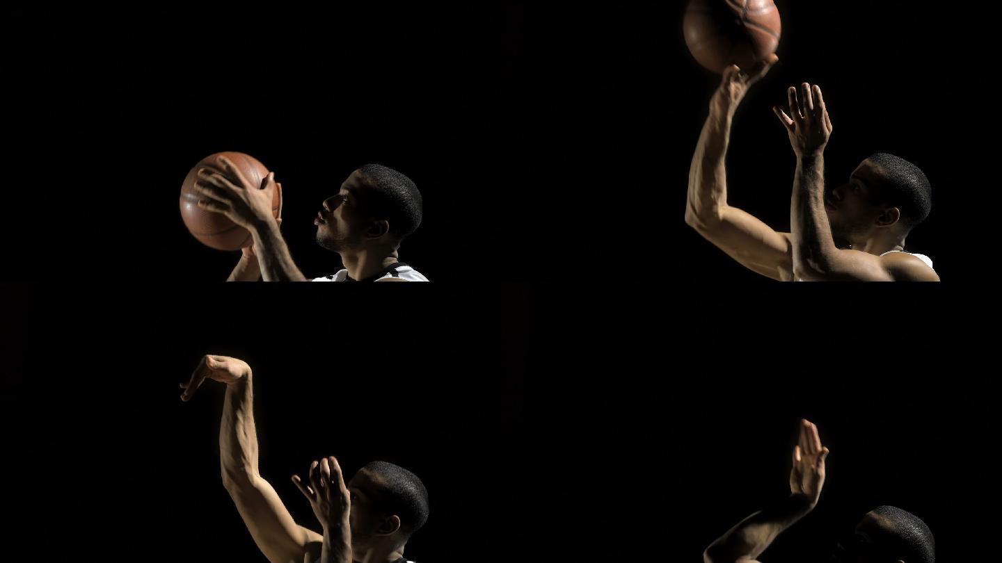一个年轻篮球运动员在黑色背景下练习投篮