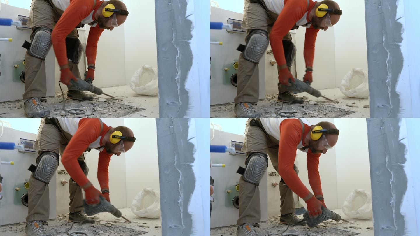 建筑工人从浴室地板上拆除旧瓷砖