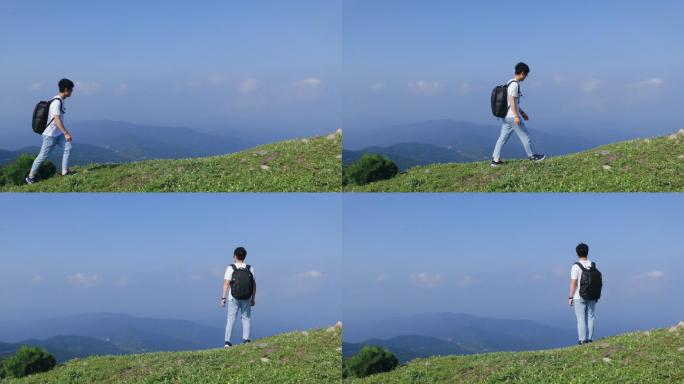 4K一个年轻男性背包在山顶上行走观看风景
