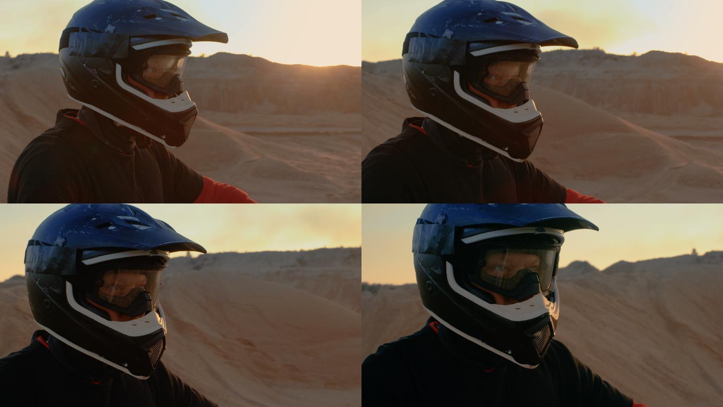 摩托车越野车手在沙地上观察