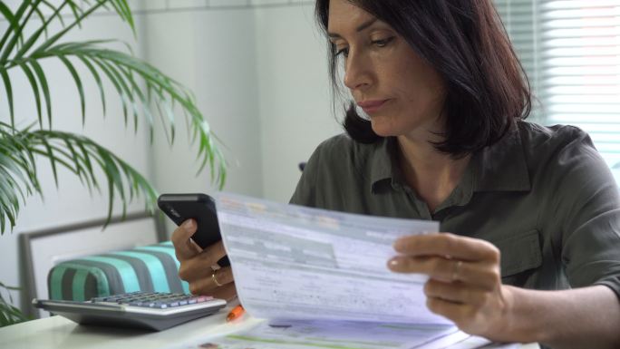 女性使用智能手机填写纳税单