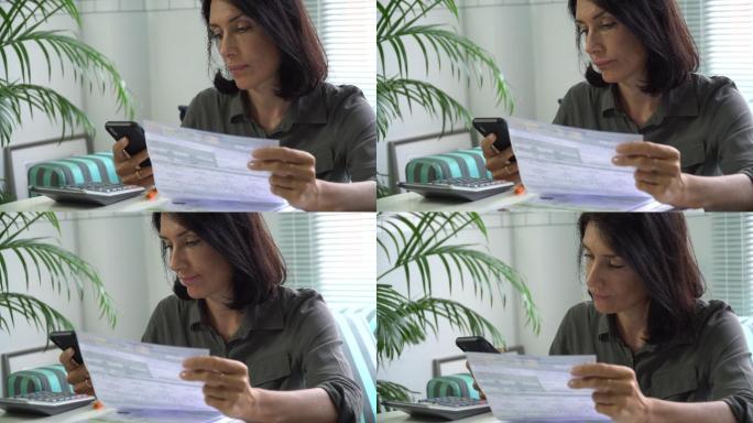 女性使用智能手机填写纳税单