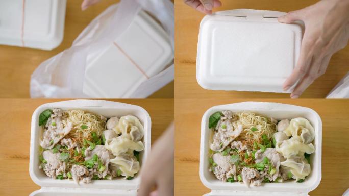 手打开泰国食物午餐盒。
