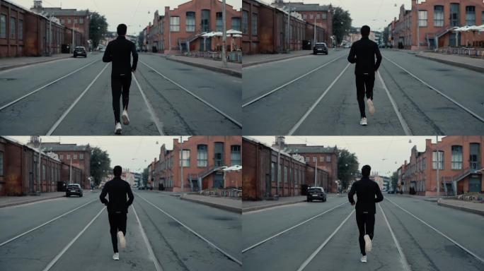 运动员在街道中间跑。
