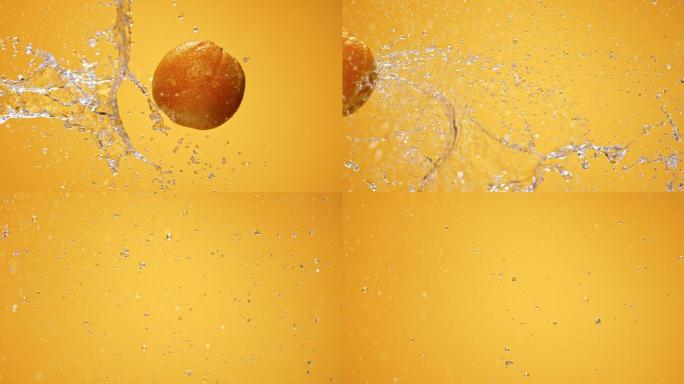 橘子被水喷射到空中