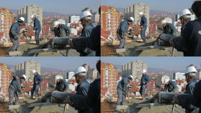 工人们在楼顶浇注混凝土