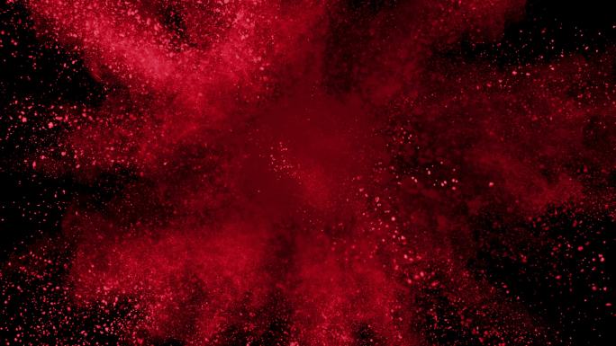 红色粉末在黑色背景上爆炸的慢动作