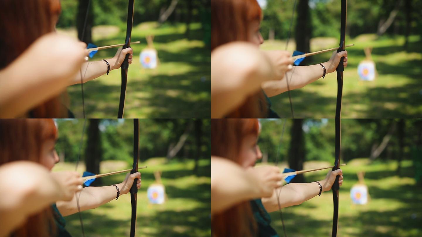 年轻的女子在野外练习射箭