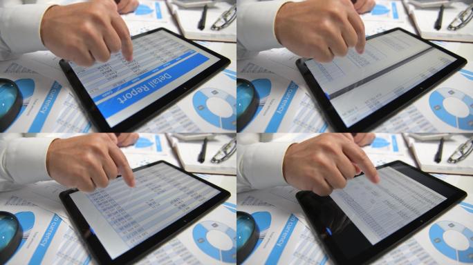 商人使用平板电脑，计算，阅读和撰写报告。