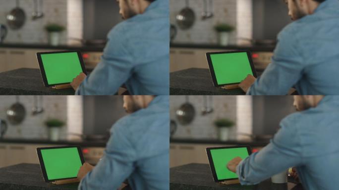 年轻人用绿色屏幕的平板电脑