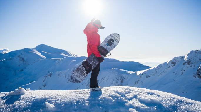 雪山顶上的滑雪板运动员准备登上滑雪坡