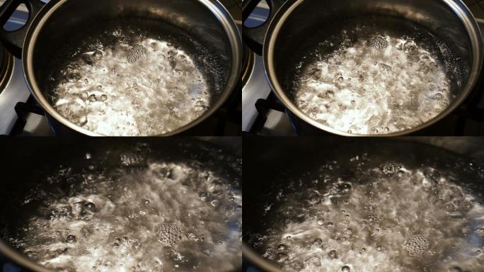 炉子上锅里的水沸腾的特写镜头。