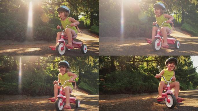 在骑三轮车的小女孩