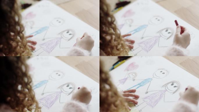 小女孩在餐桌上画画和着色