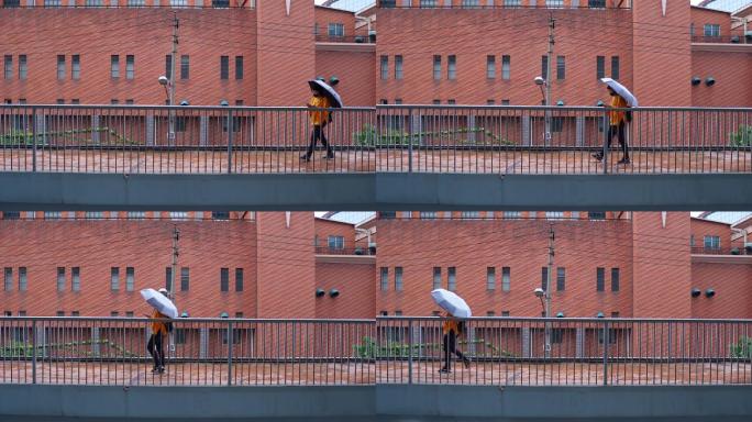 红砖墙打伞人路过城市人文