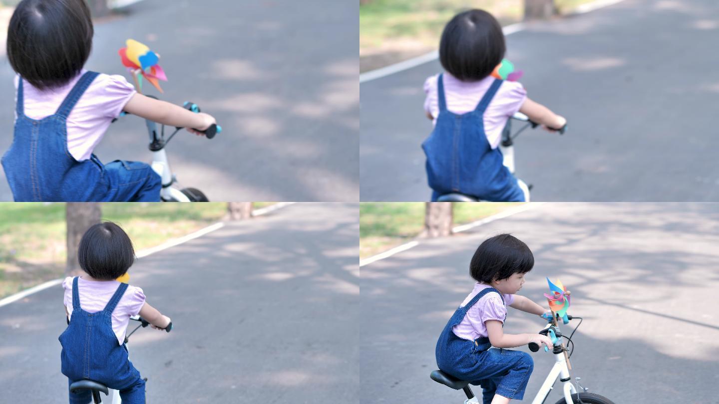 小女孩在的公园里骑自行车