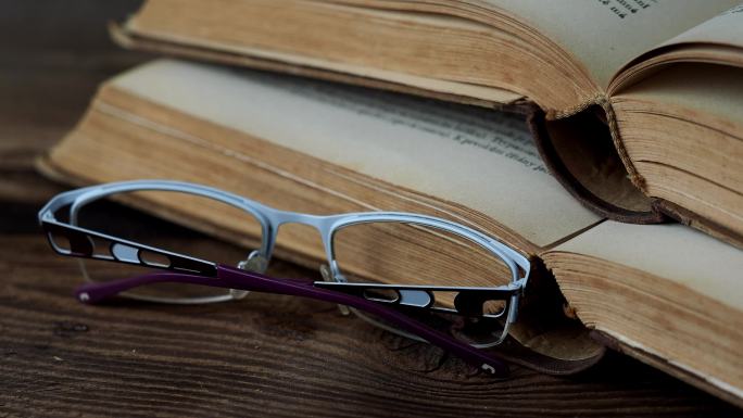 木桌上的书和眼镜