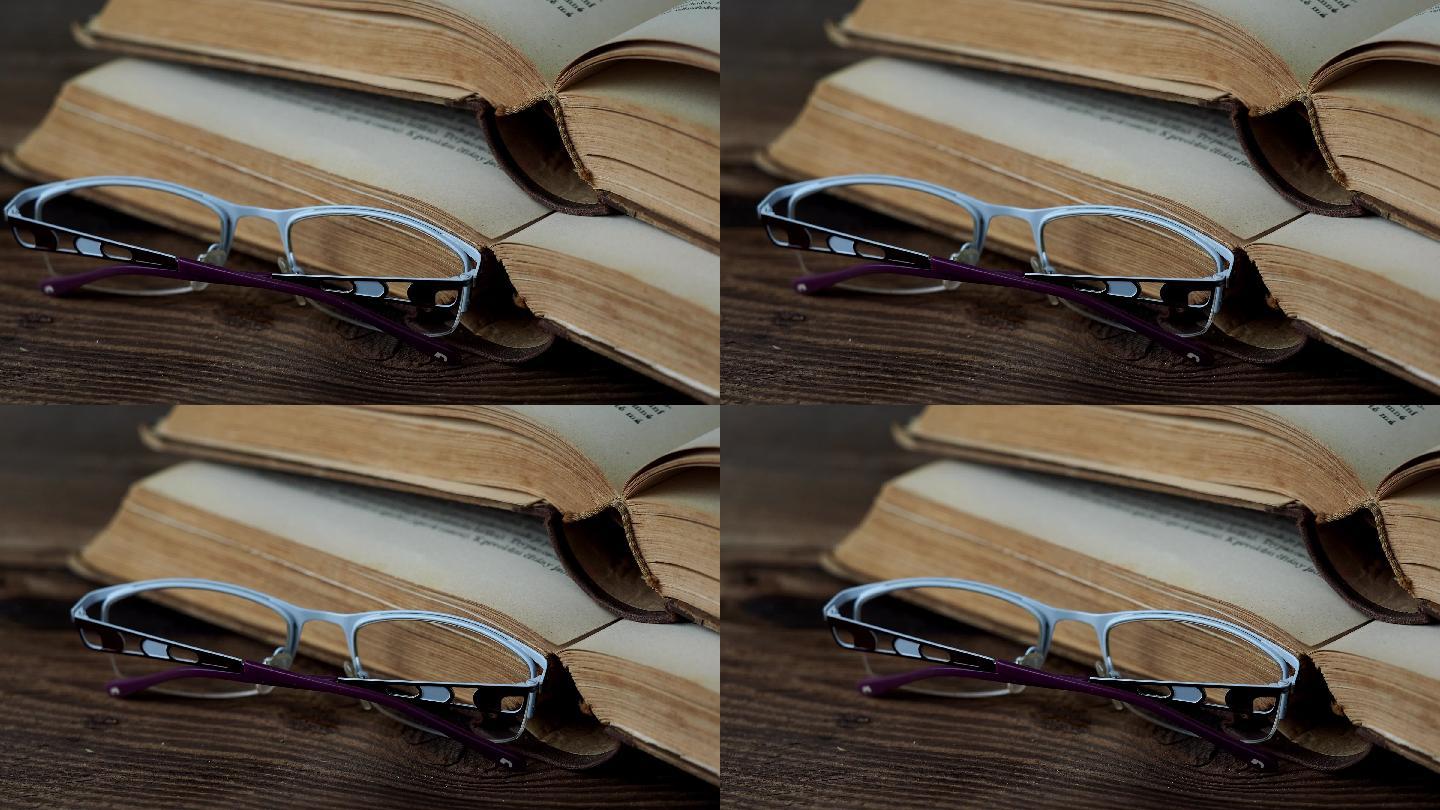 木桌上的书和眼镜