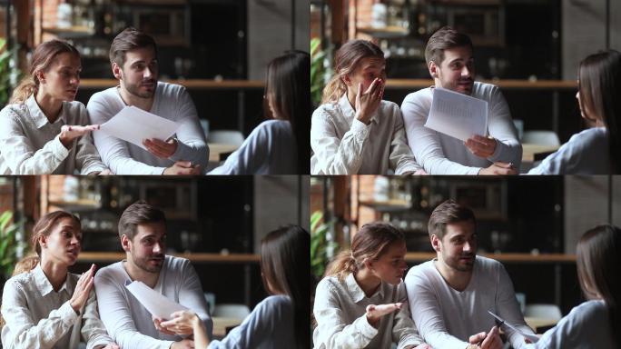 恼怒的年轻夫妇拿着文件和经理争吵