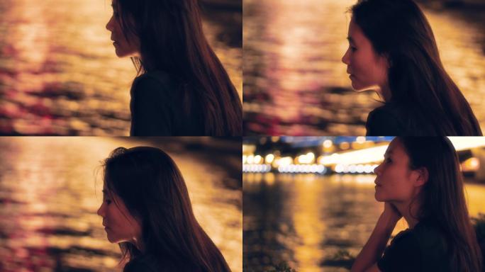 夜晚女孩独自一个人在江边吹风4k视频素材