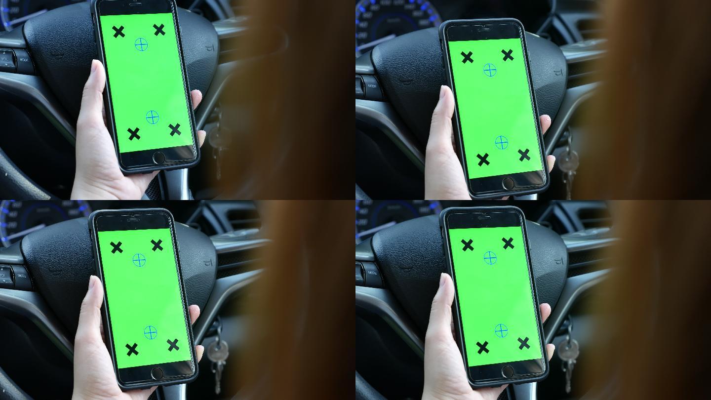 手持绿色屏幕智能手机的女士在车内的镜头
