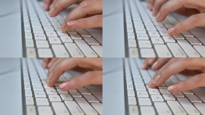 一个女人用白色键盘打字的特写镜头