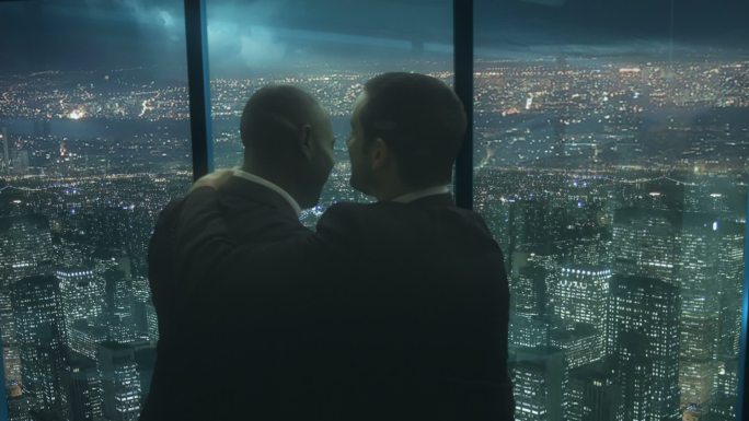 两个商人在办公室望向窗外