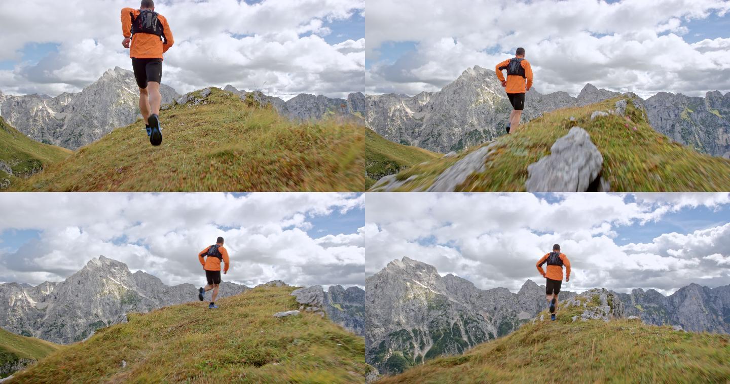 一名男性跑步者在山脊上跑步俯瞰附近的山脉