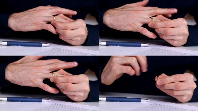 男人从手上取下一枚结婚戒指放在桌上