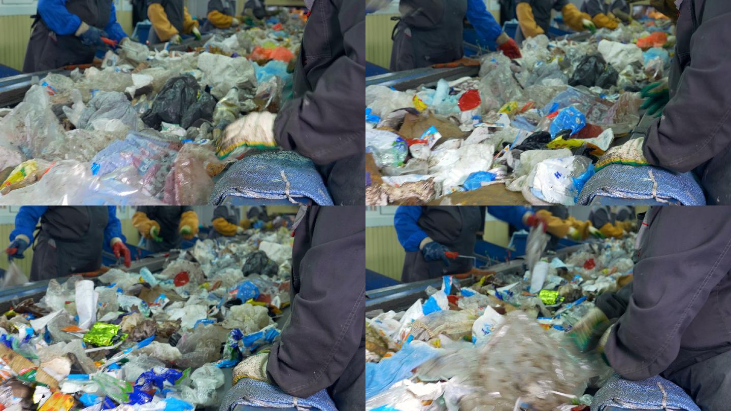 工人们在垃圾回收厂里分类处理垃圾。