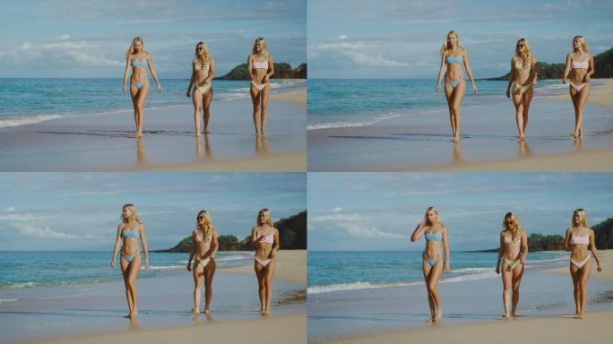 三个美女穿上泳装在海滩行走