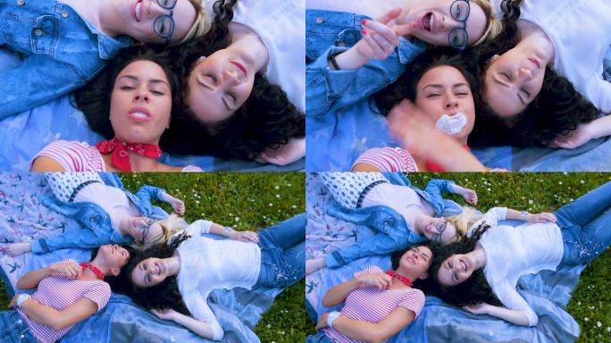 三个女孩躺在草地上