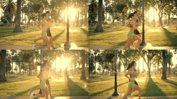 一对情侣在日出时分慢跑穿过公园。