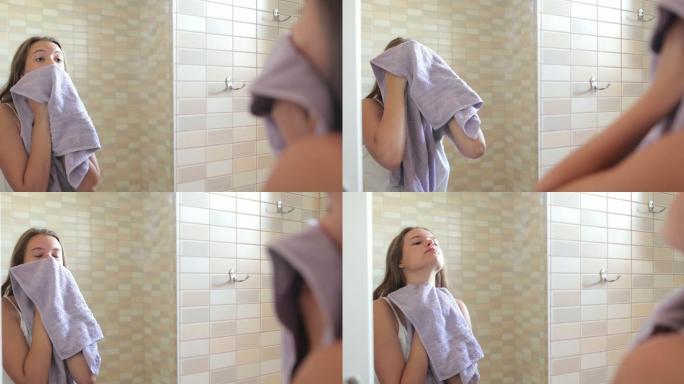 拿毛巾洗脸的女人
