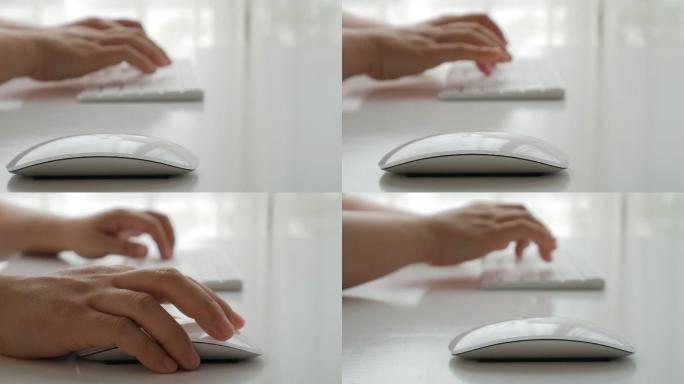 女商人用手在键盘上打字并点击电脑鼠标