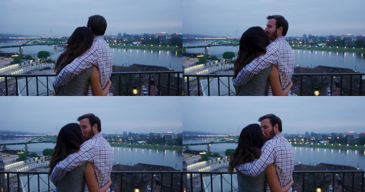情侣在浪漫约会时在楼顶接吻