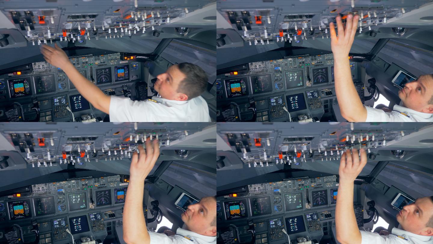 飞行员在飞行前正在切换驾驶舱上部的按钮