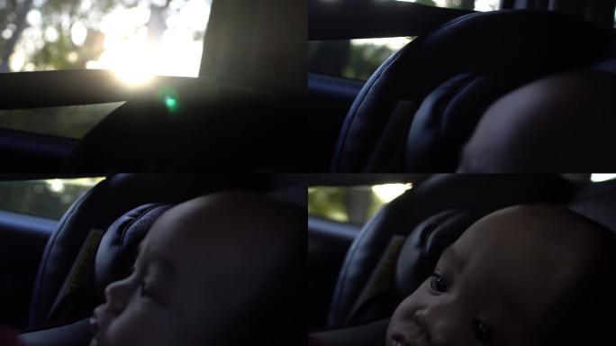 小男孩坐在车里安全观日落