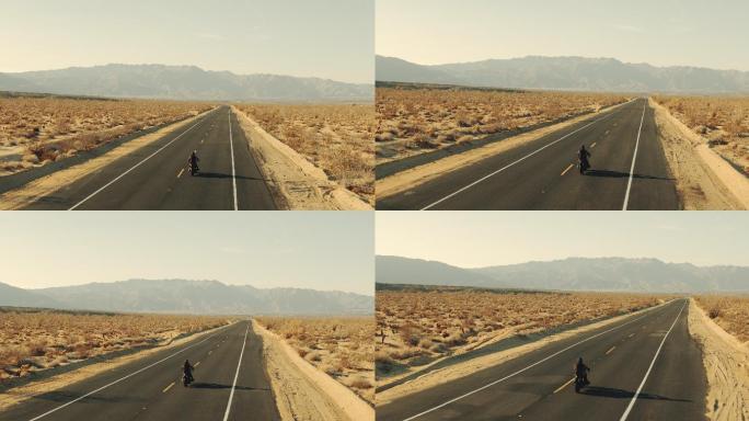 夕阳下在沙漠公路上骑摩托车